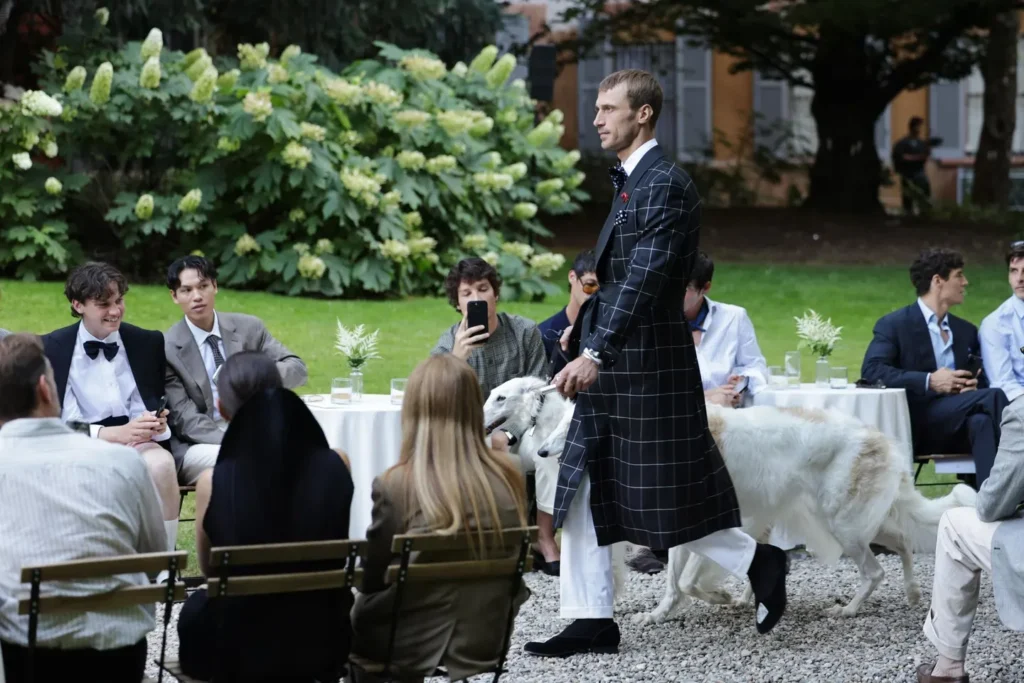 Man in checkered coat walking with dogs