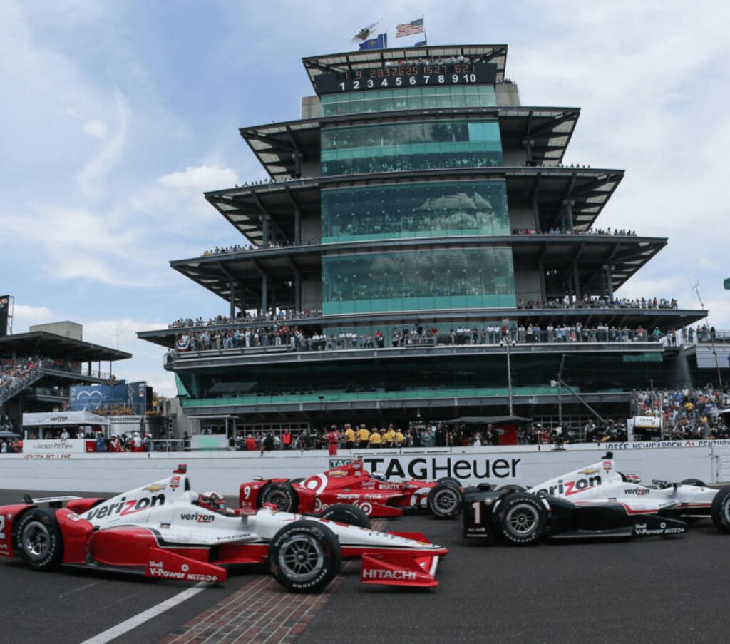 Race cars at Indianapolis Motor Speedway pagoda.