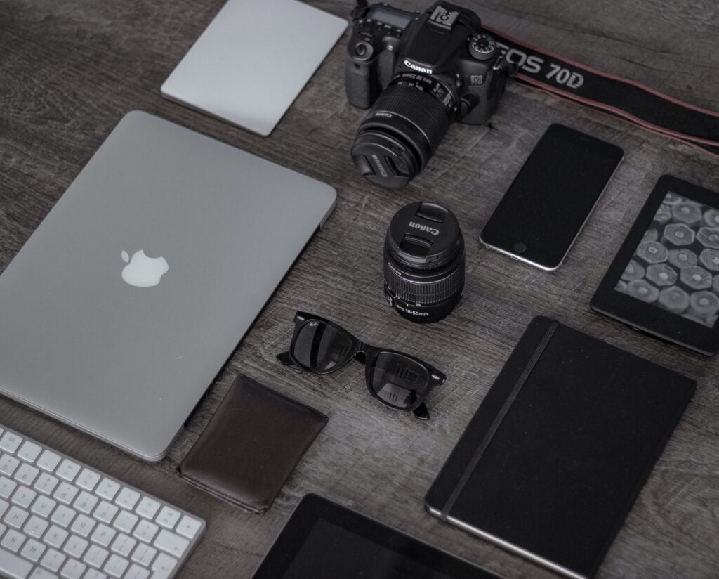Tech gadgets and accessories on a wooden desk.