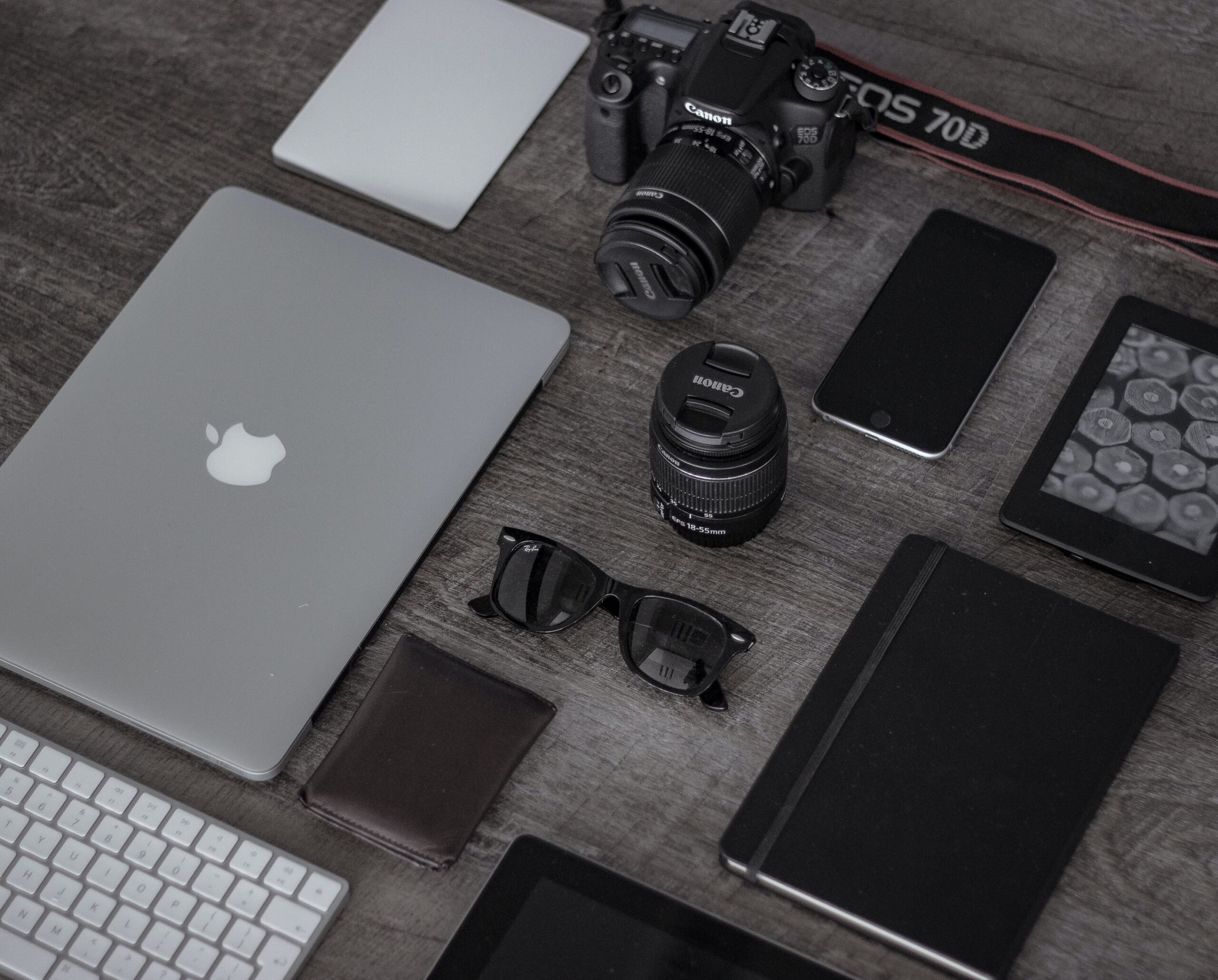 Tech gadgets and accessories on a wooden desk.
