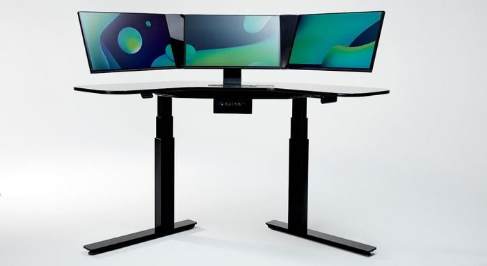 Adjustable standing desk with three monitors setup