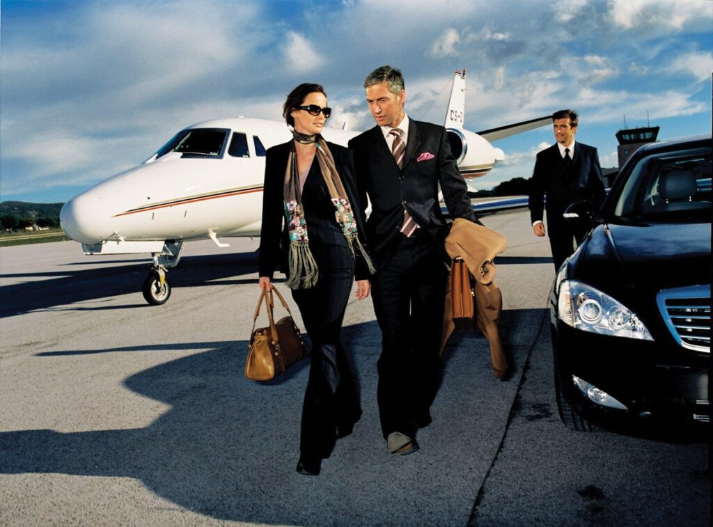 Couple walking from private jet to car
