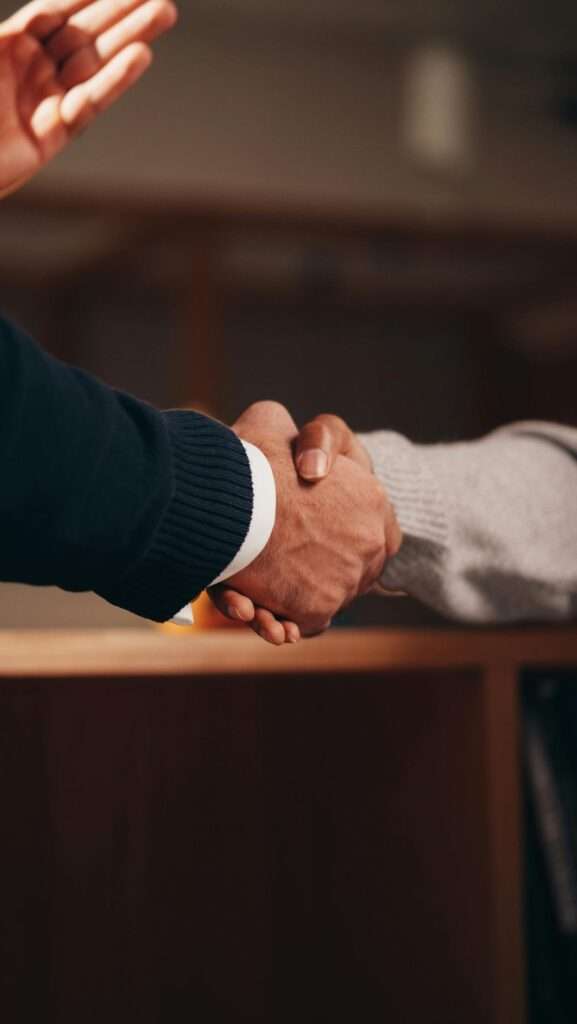 Two people shaking hands in agreement.