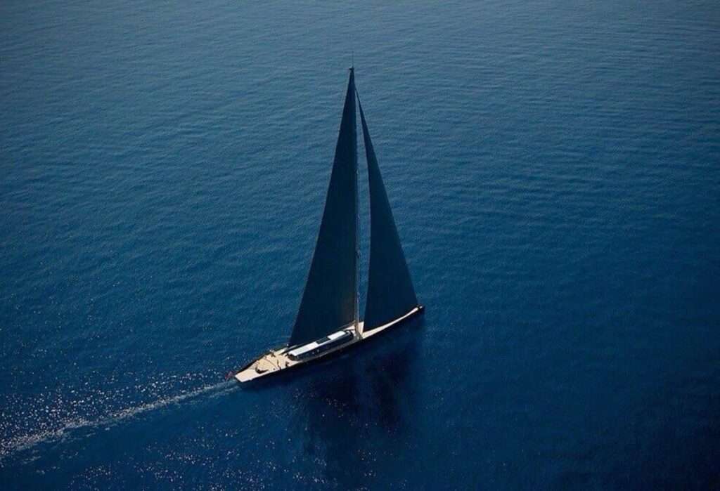 Sailboat on vast blue ocean waters.