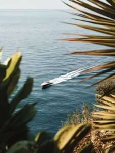 Speedboat on ocean surrounded by palm leaves