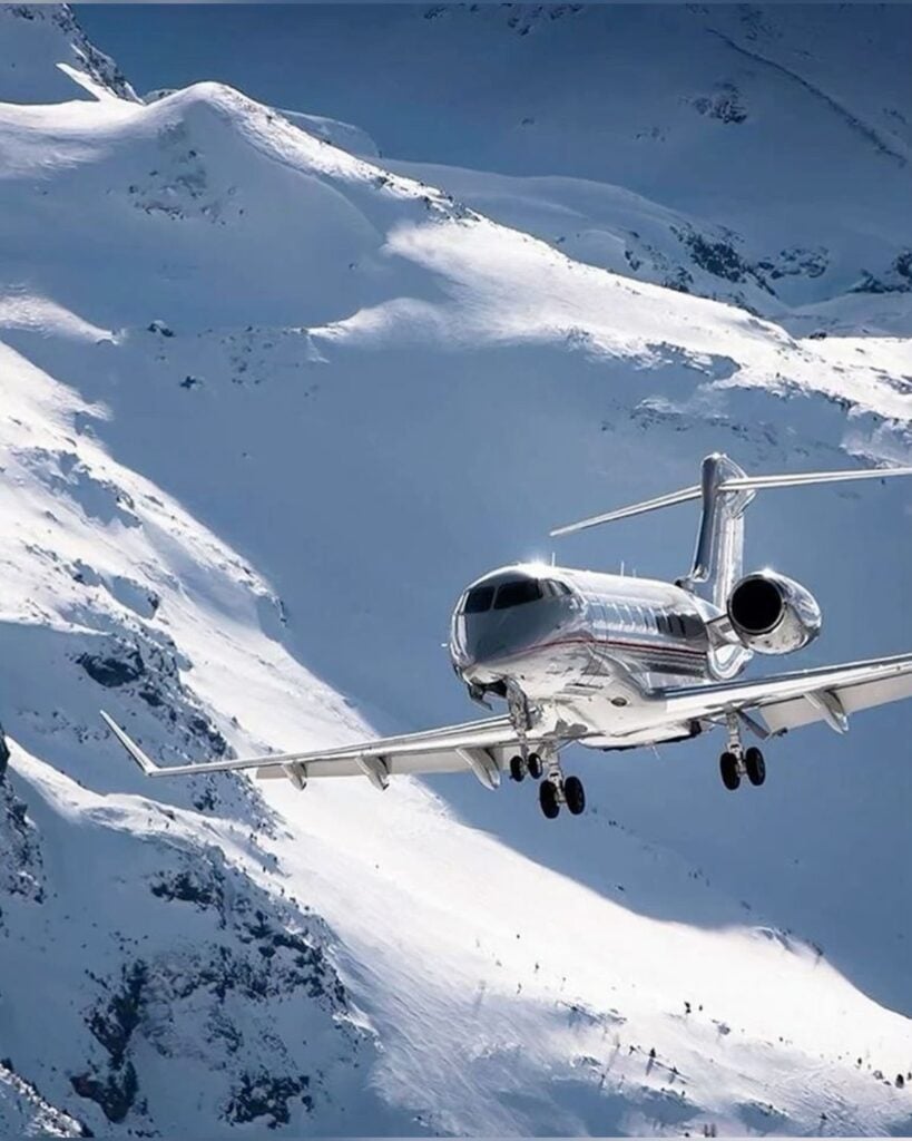 Airplane flying over snowy mountains