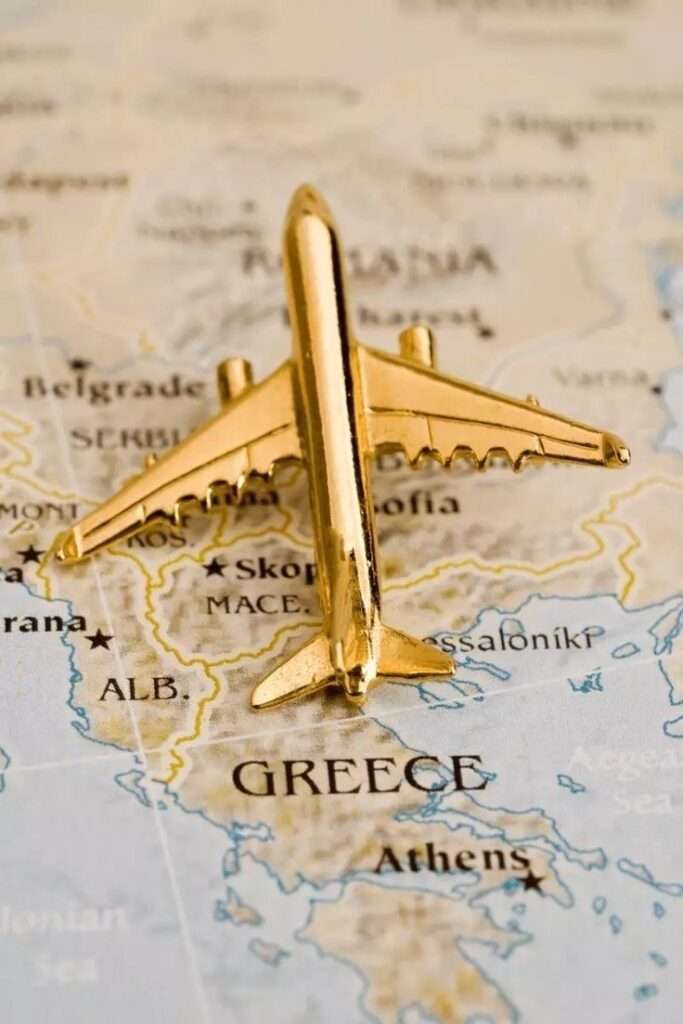 Gold airplane on map highlighting Greece.