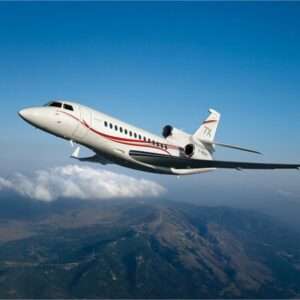 Private jet flying over mountainous landscape