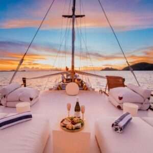 Luxury yacht deck with sunset view and refreshments.