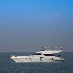 White yacht sailing on calm sea, clear sky