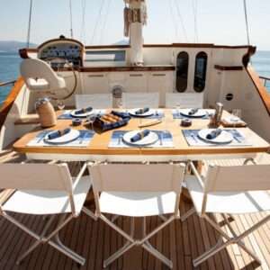 Elegant yacht dining setup with ocean view.
