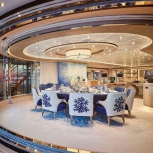 Luxurious dining room with elegant blue chairs.