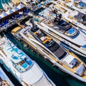 Aerial view of luxury yachts docked at marina.