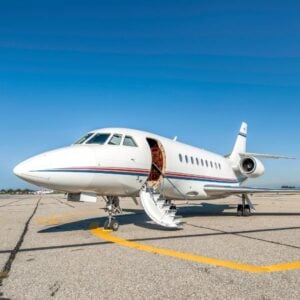 Private jet parked on airport runway