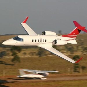 Private jet flying above landscape.