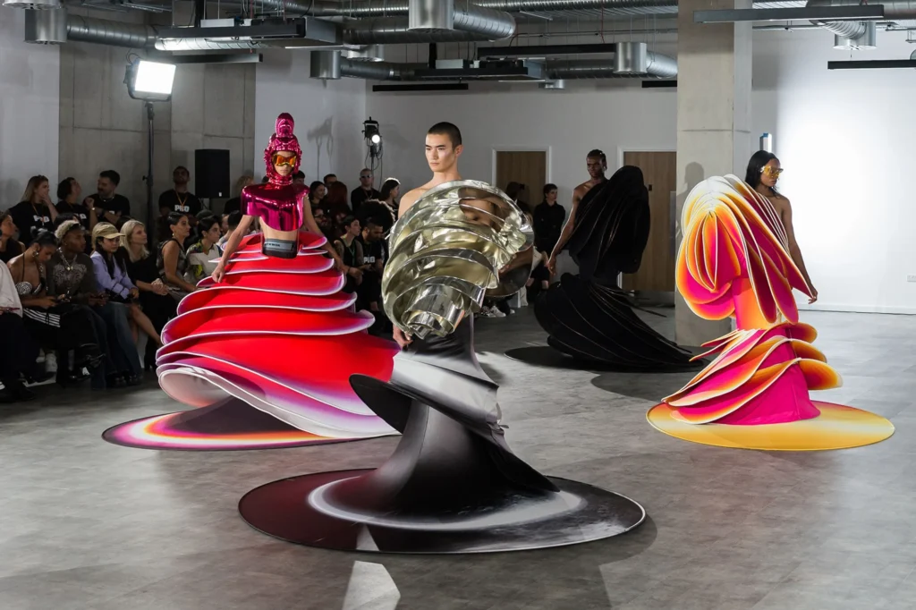 Futuristic fashion models on runway.