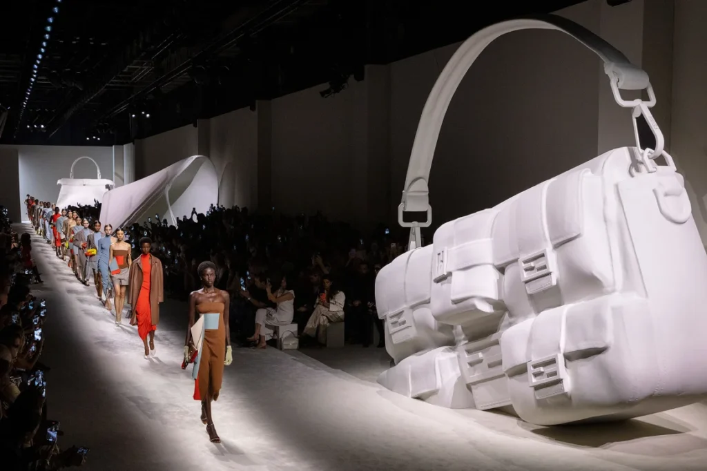 Fashion show with giant handbags as decor