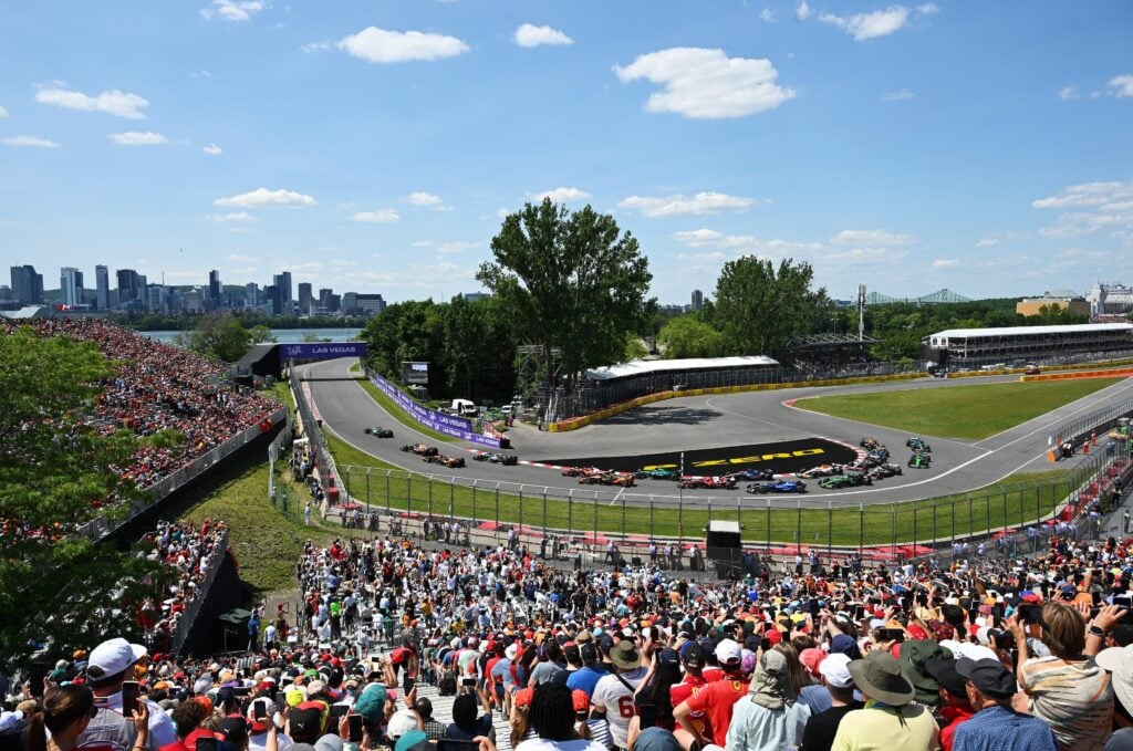 Crowded race track with city skyline background