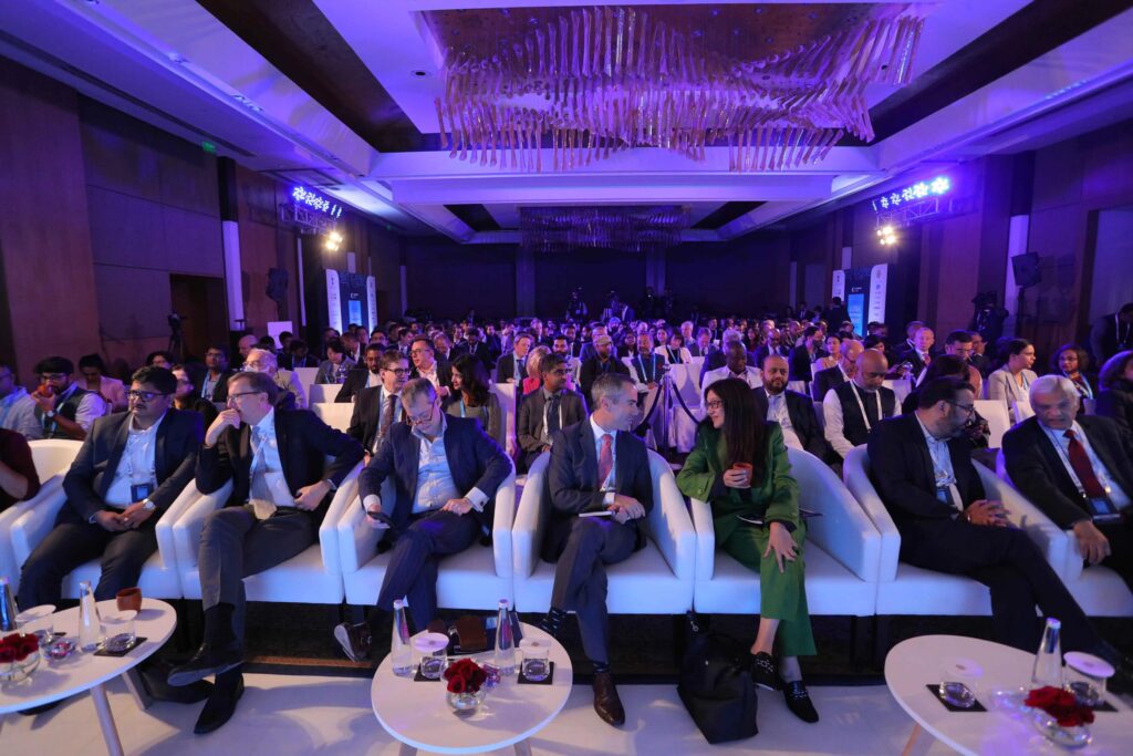 Audience seated at conference in purple-lit ballroom