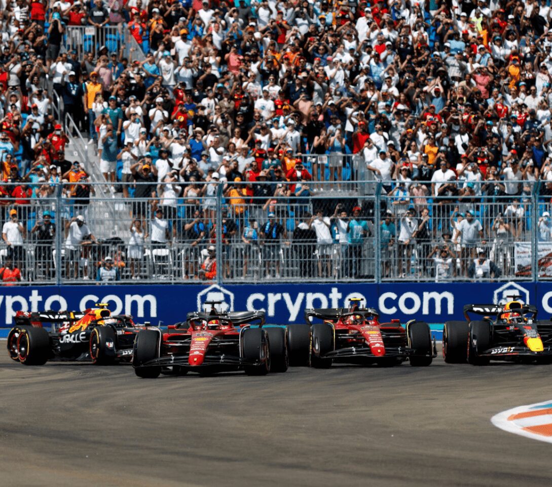 Formula 1 cars racing with cheering crowd