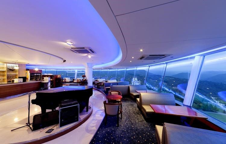 Modern lounge with grand piano and panoramic view