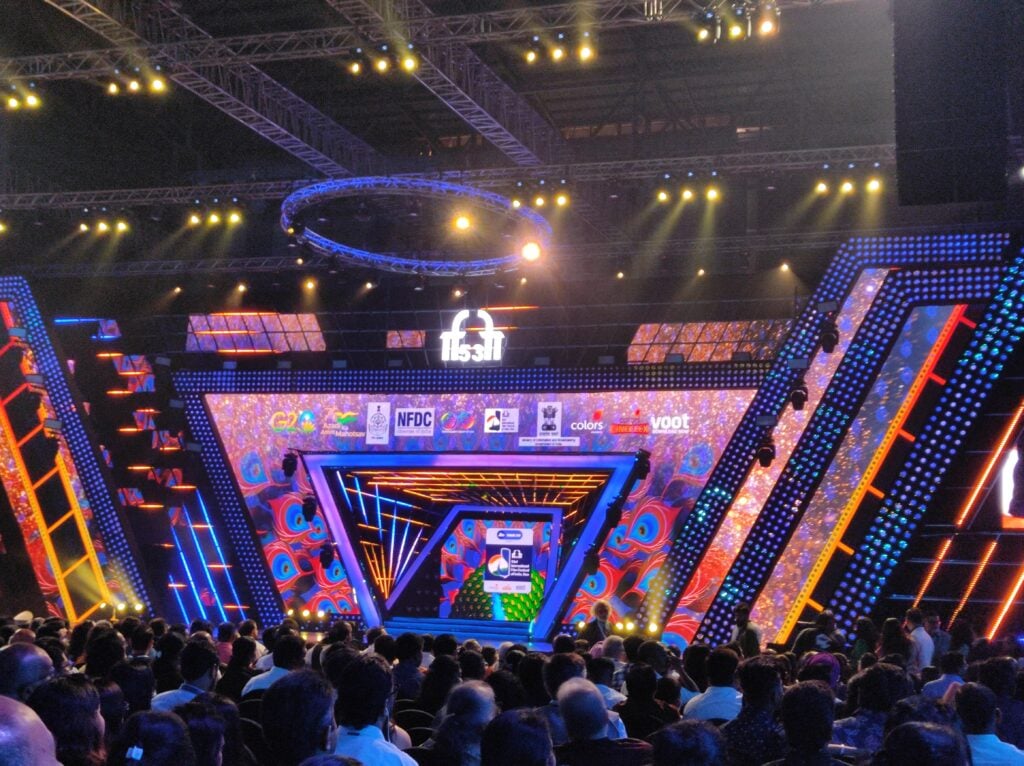 Colorful awards stage with large audience indoors
