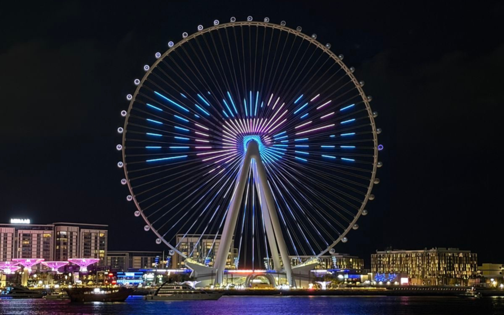 Illuminated Ferris wheel at night.