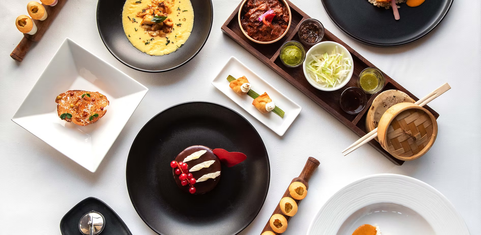 Overhead view of gourmet dishes and plated desserts