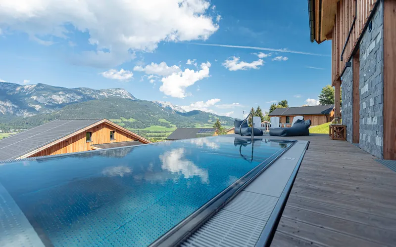 Infinity pool with mountain view and blue sky