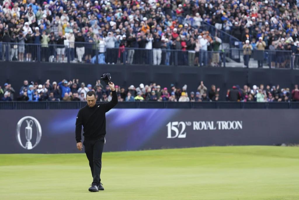 Golfer tipping hat to audience
