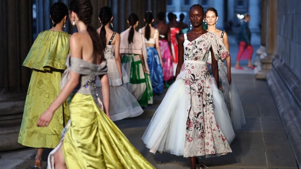 Models wearing elegant floral dresses on runway