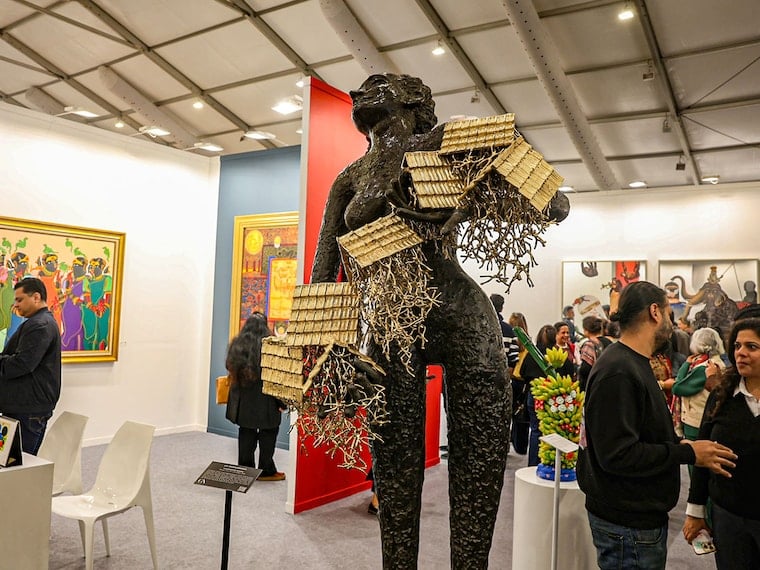 Tall sculpture with houses in art gallery
