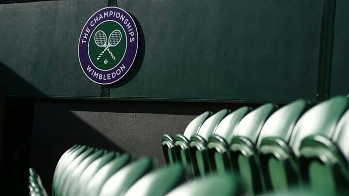 Wimbledon logo above empty green seats