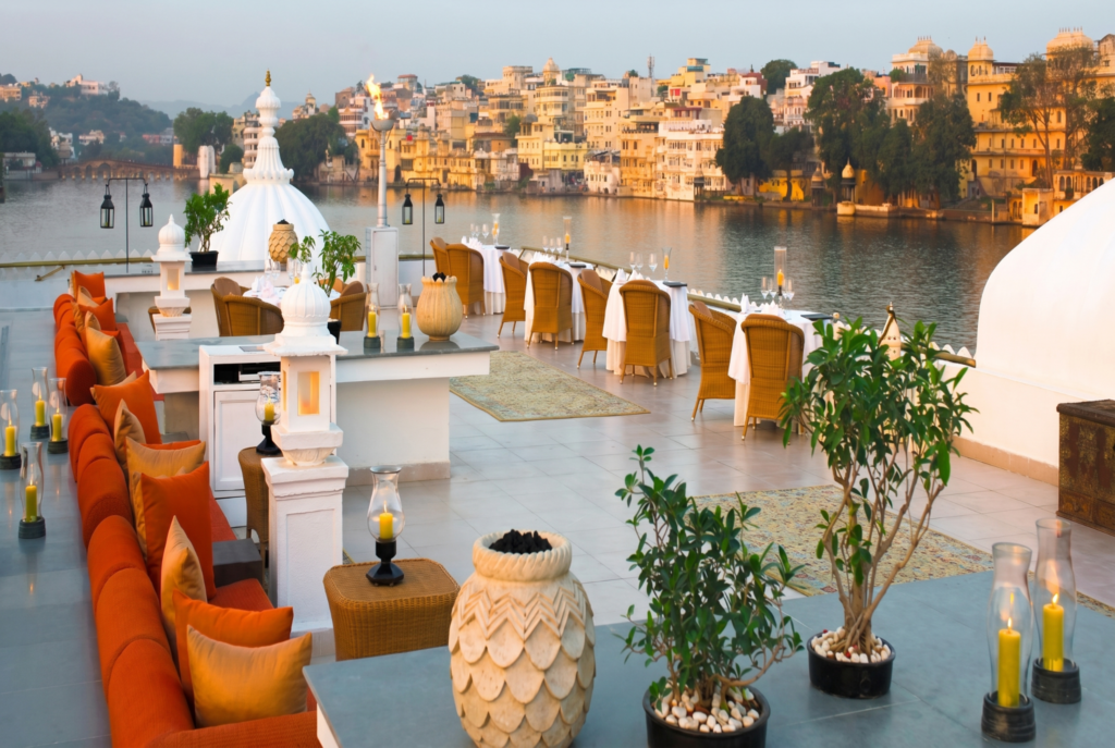 Rooftop dining terrace overlooking lake at sunset