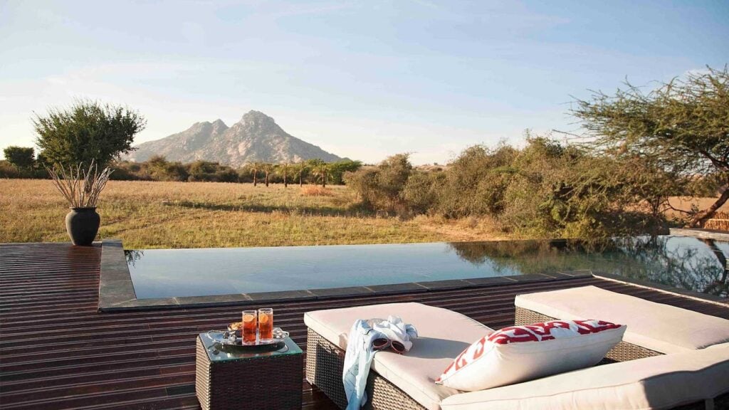 Infinity pool with mountain view and lounge chairs