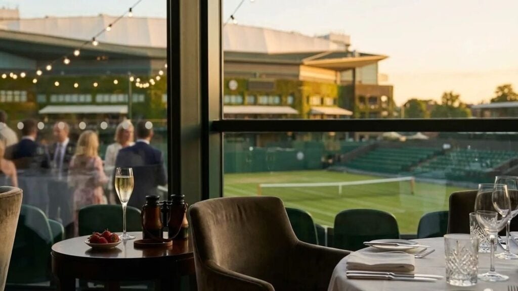 Restaurant view overlooking tennis court at sunset.