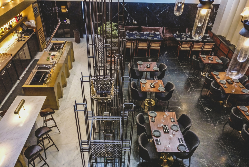 Upscale modern restaurant interior with bar and tables