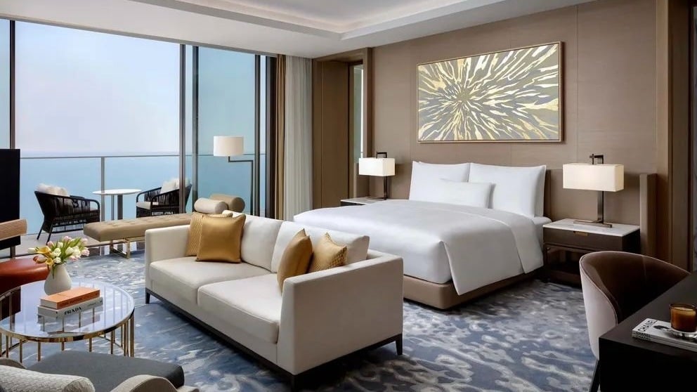 Luxury hotel room with modern decor and sea view.