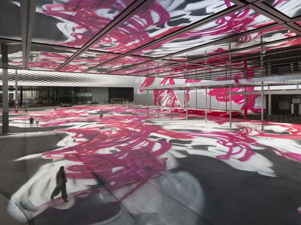 Colorful abstract art installation with people walking.