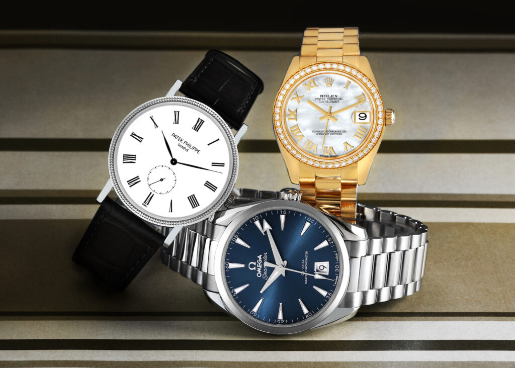 Three luxury wristwatches: Patek, Rolex, Omega