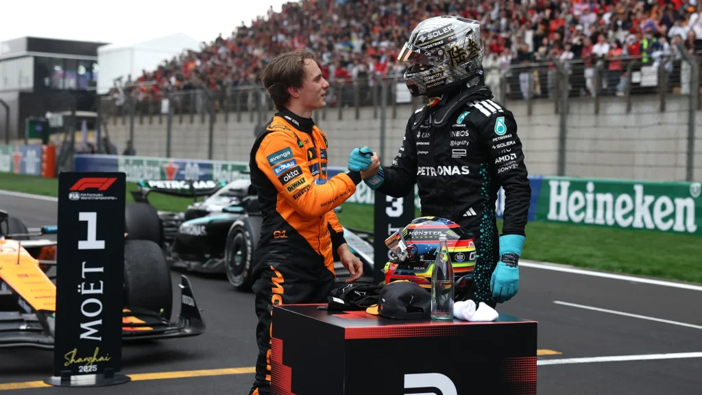 Two drivers, shaking hands after Formula 1 race.