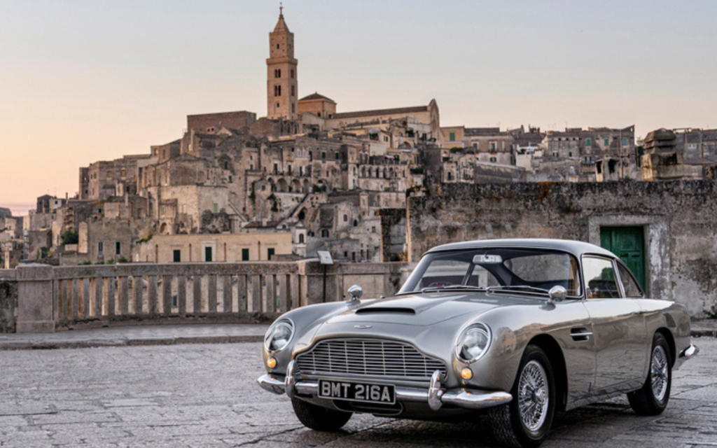 Classic car with ancient city backdrop