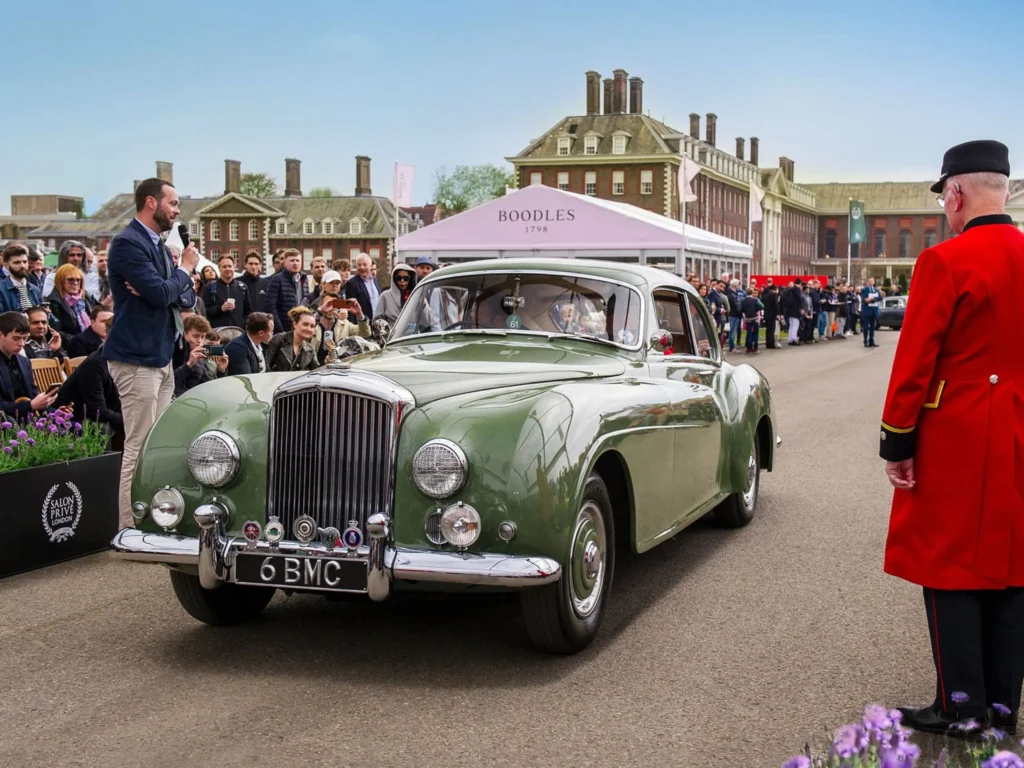 Vintage green car at a classic car event.