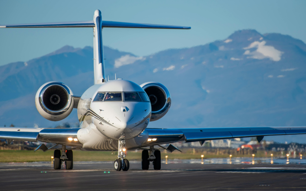 Private jet on runway with mountains