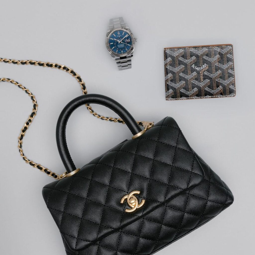 Black quilted Chanel bag with luxury accessories